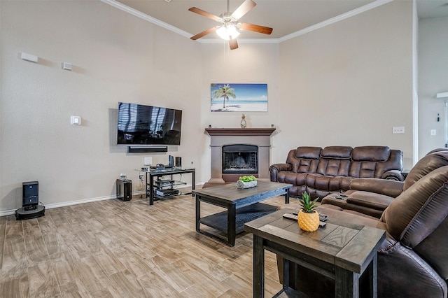 living room featuring crown molding, ceiling fan, and hardwood / wood-style flooring