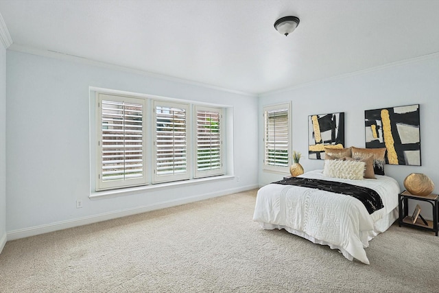 carpeted bedroom with baseboards and ornamental molding