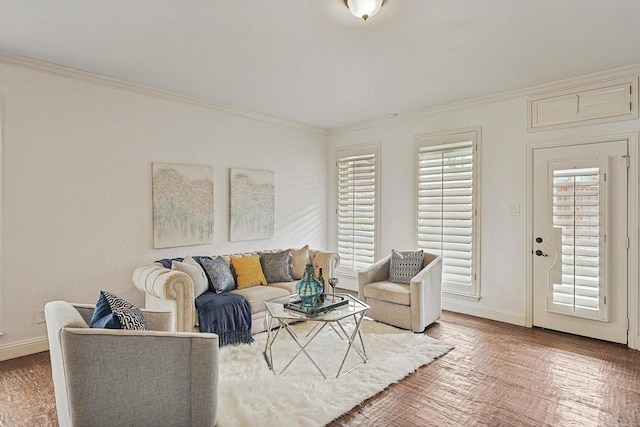 living area with crown molding, baseboards, and wood finished floors