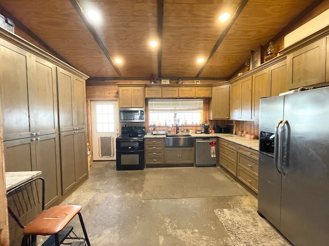 kitchen featuring sink, stainless steel appliances, concrete floors, and a healthy amount of sunlight