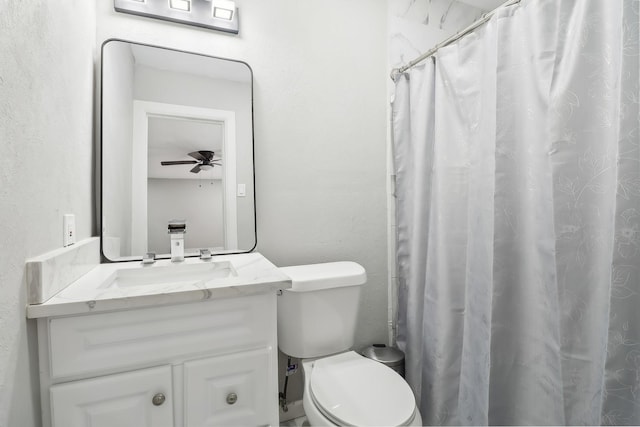 bathroom with vanity, ceiling fan, toilet, and walk in shower