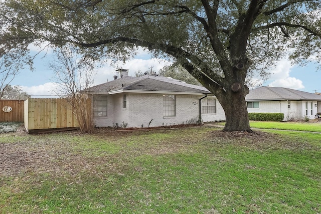 view of side of home with a lawn