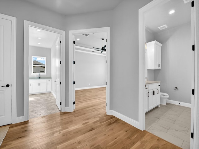 hall featuring sink and light hardwood / wood-style flooring