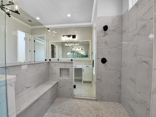 bathroom with crown molding and tiled shower