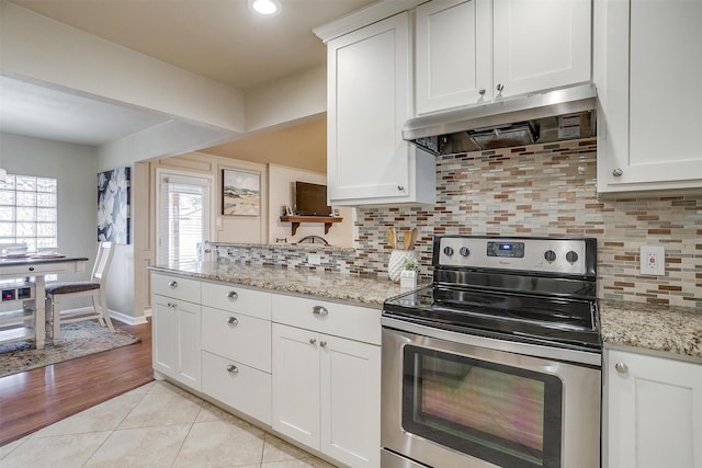 kitchen with white cabinetry, light stone countertops, and stainless steel range with electric cooktop