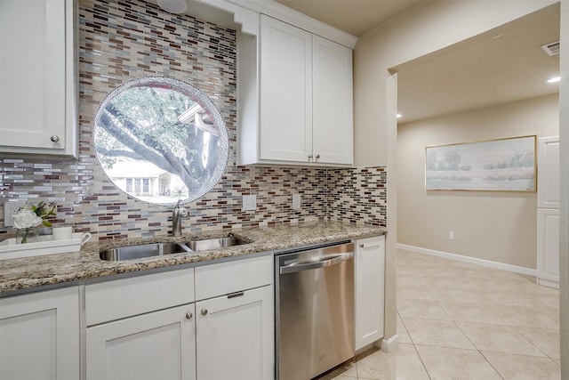 kitchen with sink, light stone counters, tasteful backsplash, white cabinets, and stainless steel dishwasher