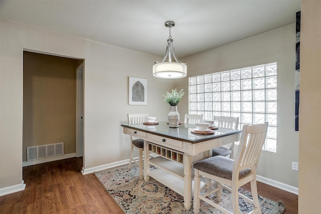 dining area with wood-type flooring