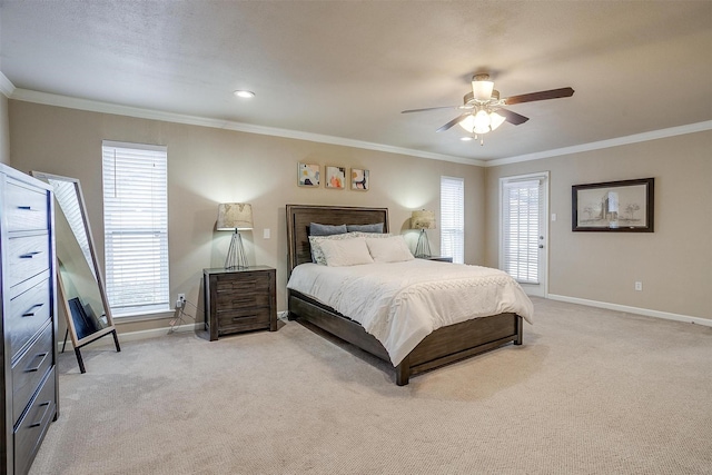 carpeted bedroom featuring crown molding and ceiling fan