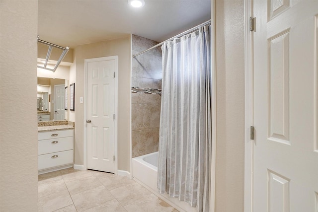 bathroom with vanity, shower / bathtub combination with curtain, and tile patterned floors