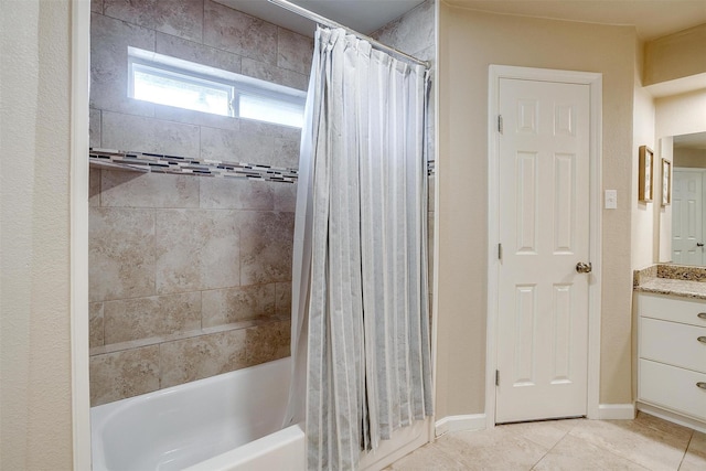 bathroom featuring tile patterned flooring, vanity, and shower / bath combo with shower curtain