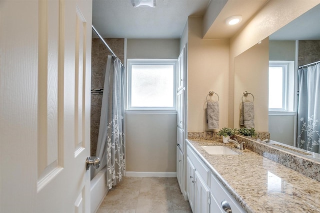 bathroom featuring vanity, plenty of natural light, shower / bath combo, and tile patterned floors