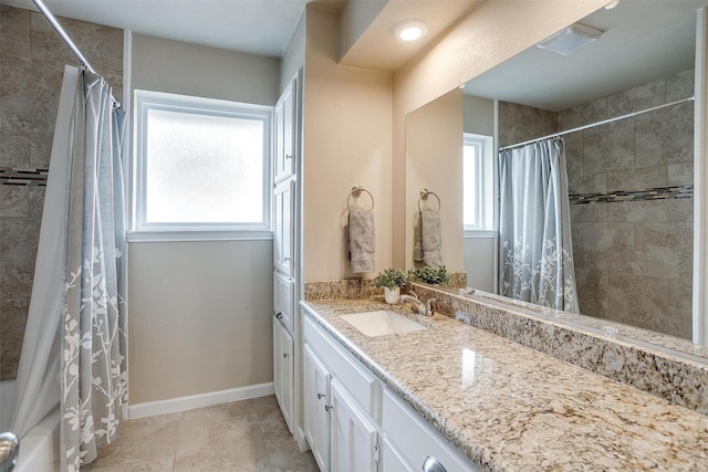 bathroom featuring tile patterned flooring, vanity, a healthy amount of sunlight, and shower / bathtub combination with curtain