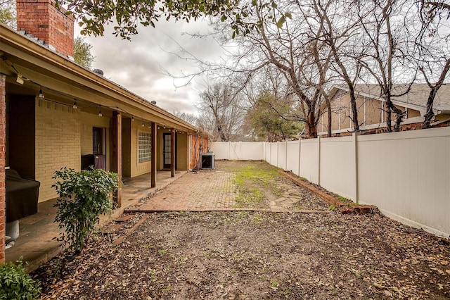 view of yard with cooling unit and a patio area