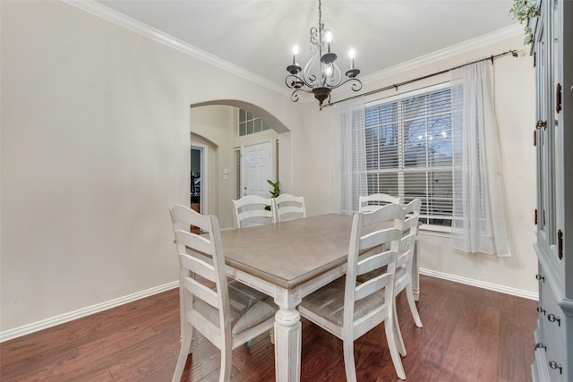 dining room featuring an inviting chandelier, ornamental molding, and dark hardwood / wood-style floors