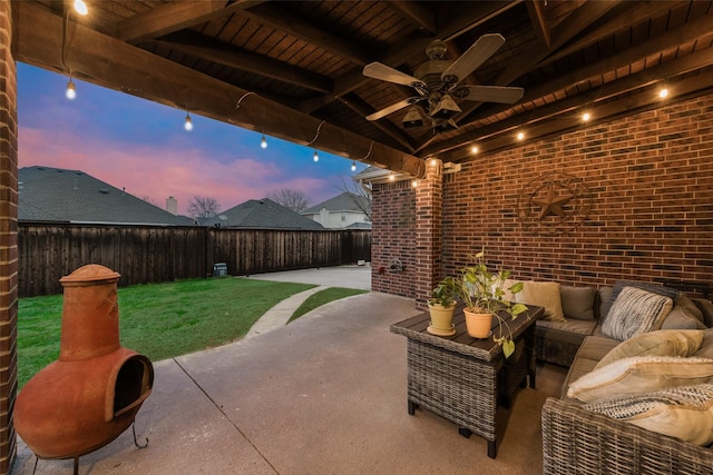 patio terrace at dusk with outdoor lounge area and ceiling fan