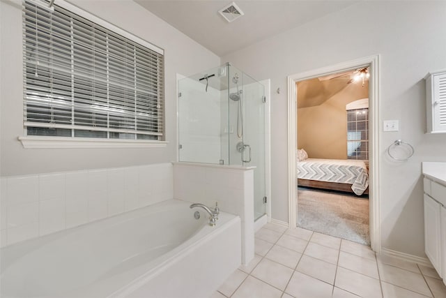 bathroom featuring vanity, independent shower and bath, and tile patterned flooring