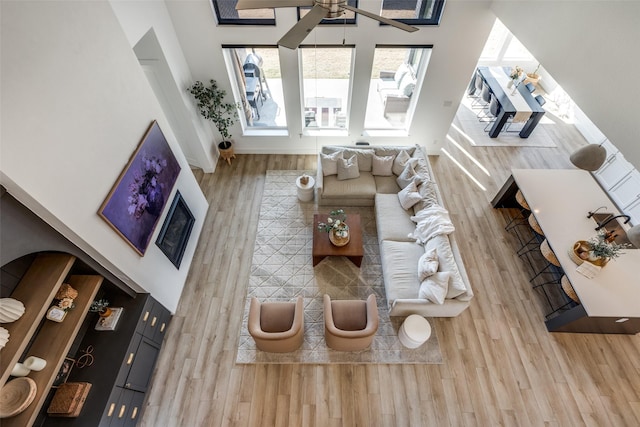 living room featuring hardwood / wood-style floors and ceiling fan