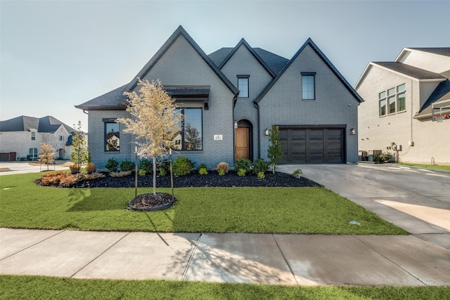 french country inspired facade with a garage and a front lawn