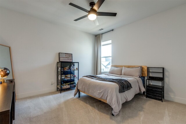 bedroom with ceiling fan and light colored carpet