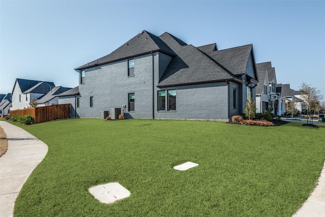 view of home's exterior featuring cooling unit and a lawn