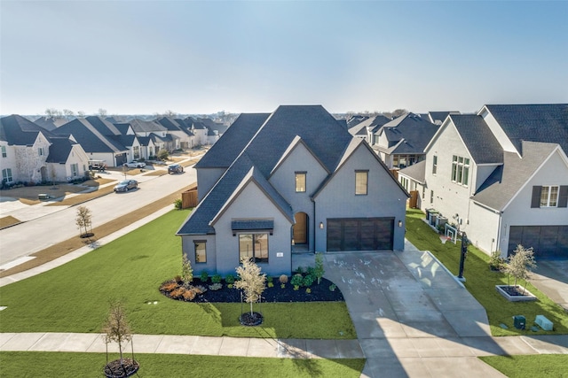 view of front of house with a garage and a front yard