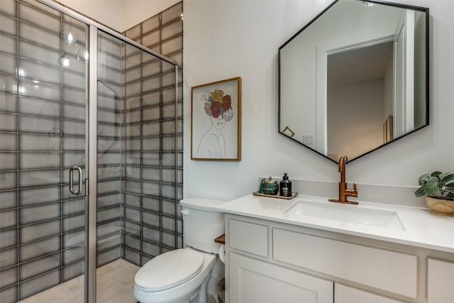 bathroom featuring vanity, toilet, and a shower with door