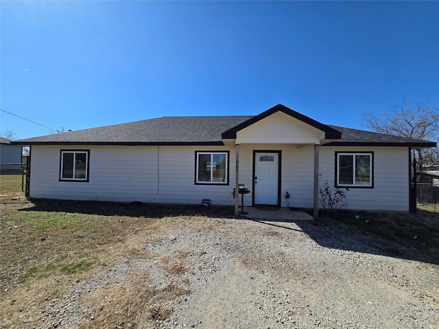 ranch-style home featuring fence