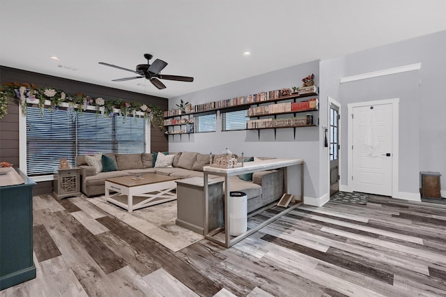 living room featuring ceiling fan and light hardwood / wood-style floors