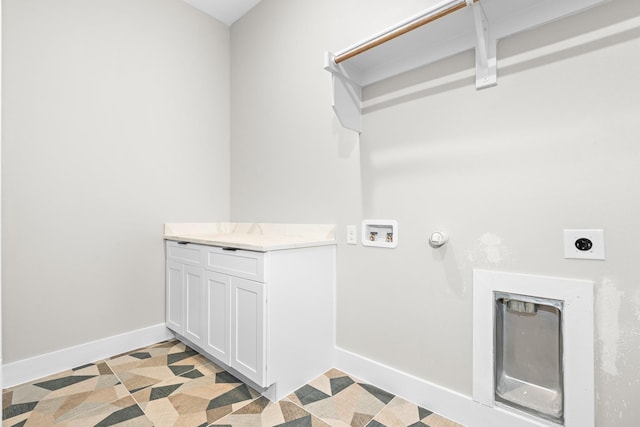 laundry area featuring electric dryer hookup, washer hookup, and cabinets