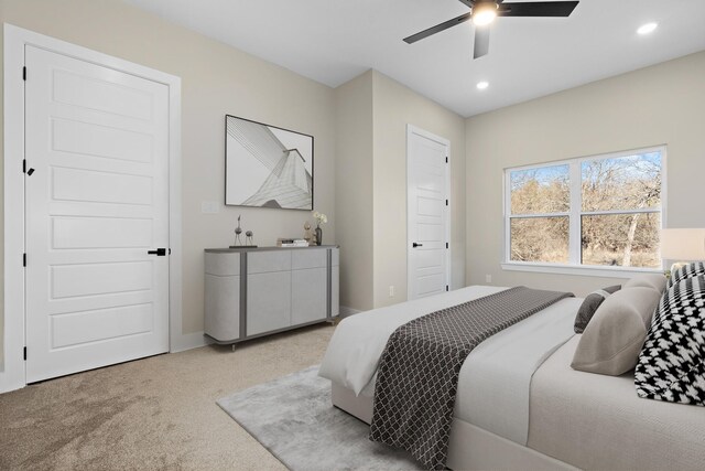 bedroom featuring light carpet and ceiling fan
