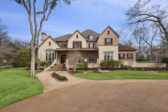 view of front of house with covered porch and a front yard