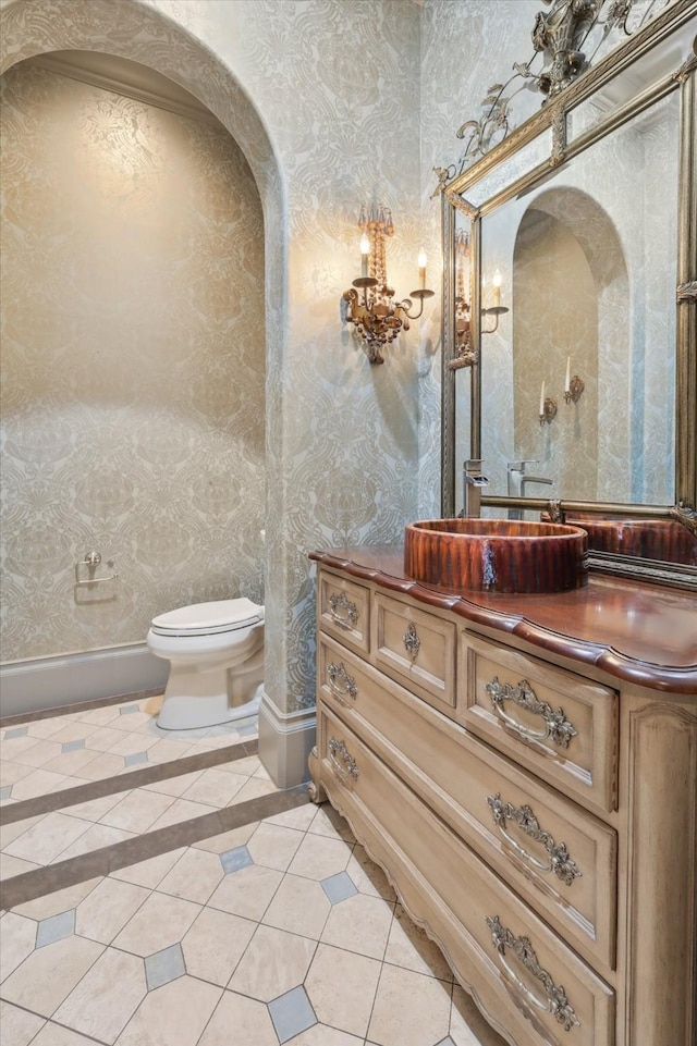 bathroom featuring vanity, tile patterned floors, and toilet