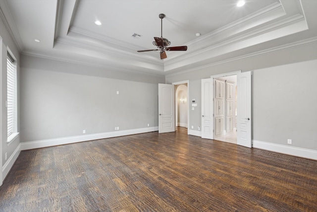 unfurnished bedroom with dark hardwood / wood-style floors, ornamental molding, a raised ceiling, and ceiling fan