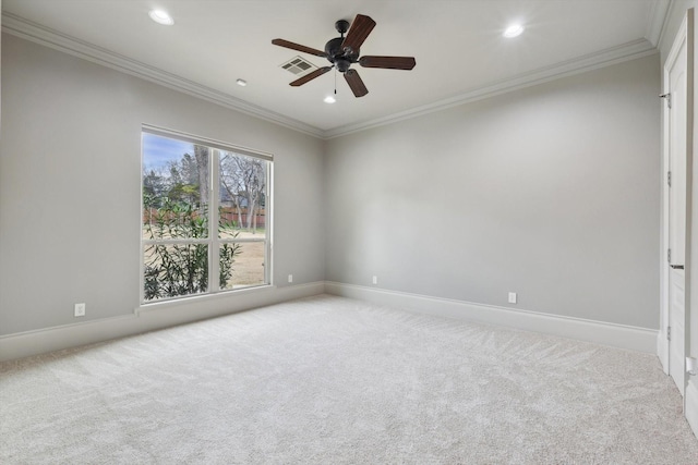 spare room with crown molding, light colored carpet, and ceiling fan