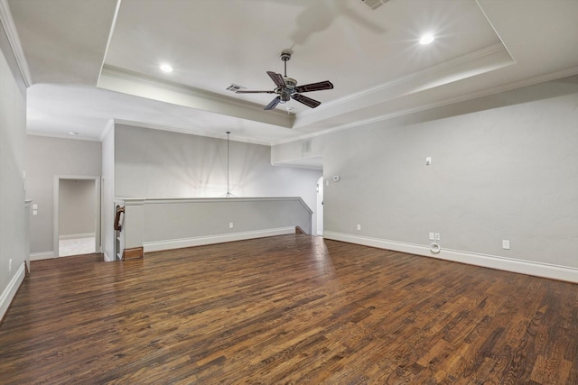 unfurnished living room with ceiling fan, dark hardwood / wood-style flooring, and a tray ceiling