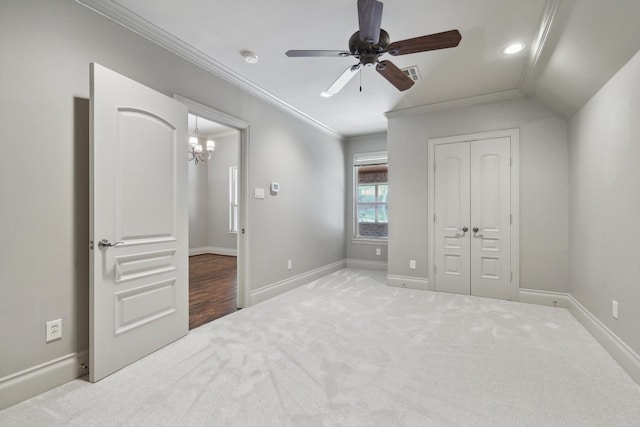 carpeted bedroom with ornamental molding, ceiling fan, and a closet