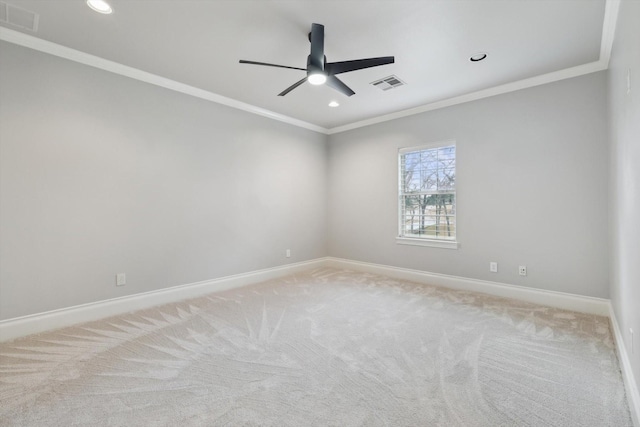 carpeted empty room with crown molding and ceiling fan