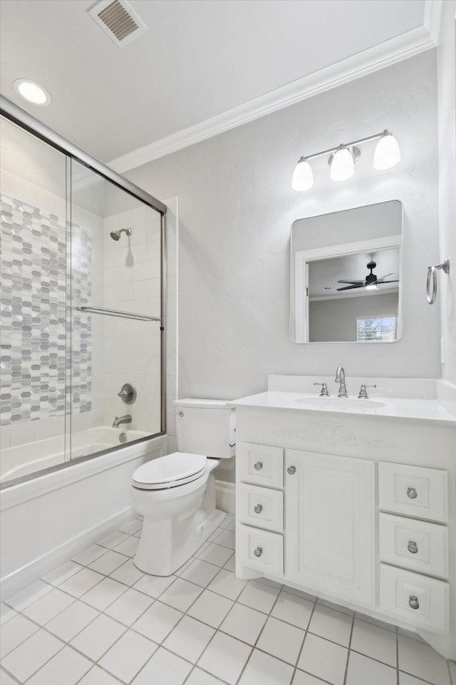 full bathroom featuring enclosed tub / shower combo, vanity, toilet, crown molding, and tile patterned floors