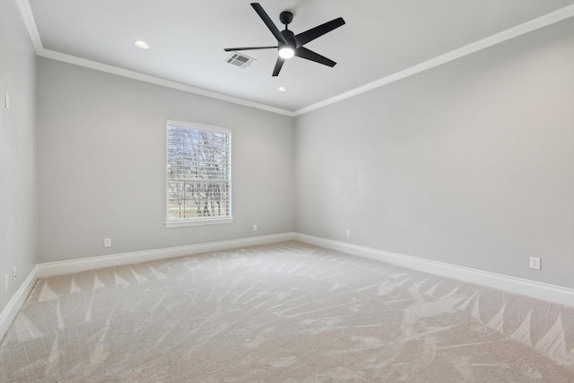 empty room with ceiling fan, light colored carpet, and ornamental molding