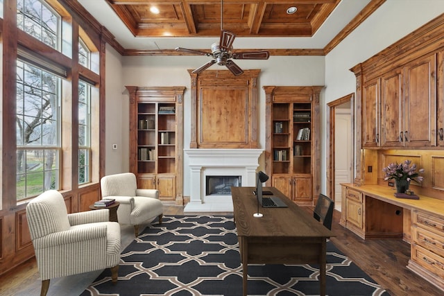 living area featuring a high ceiling, coffered ceiling, built in desk, ornamental molding, and dark hardwood / wood-style flooring