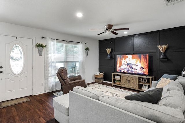 living room with dark hardwood / wood-style floors and ceiling fan