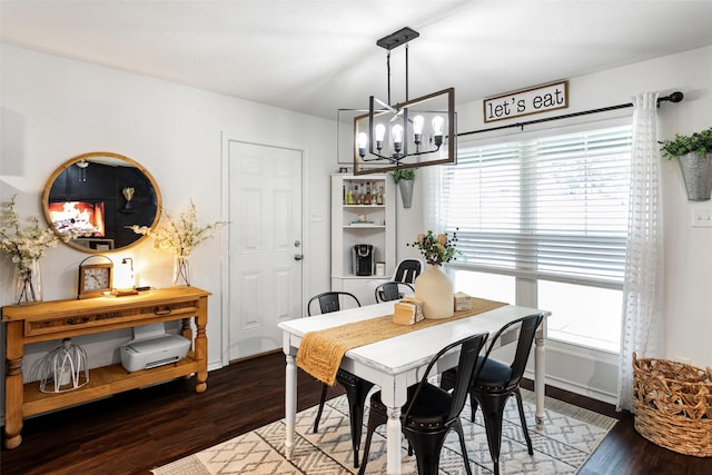 dining area with dark hardwood / wood-style flooring and a chandelier