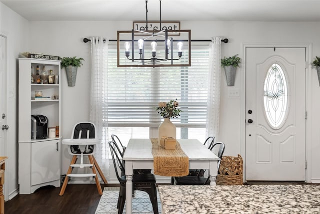 dining room featuring an inviting chandelier and dark hardwood / wood-style floors