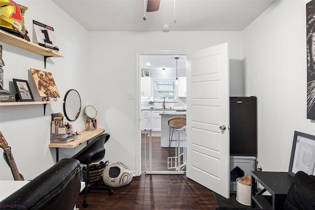 office space with ceiling fan, sink, and dark hardwood / wood-style flooring