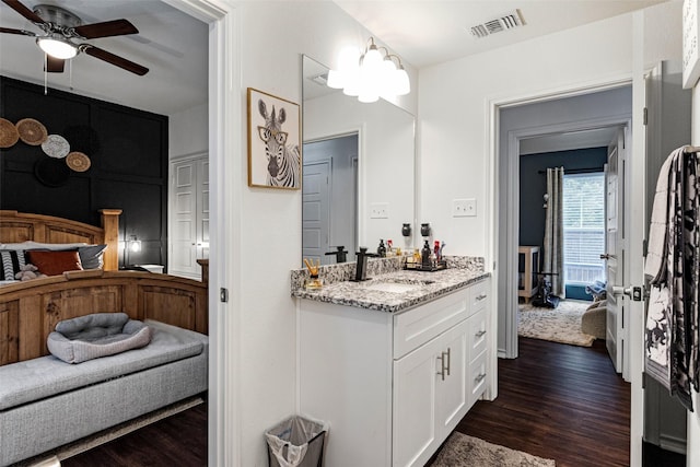 bathroom featuring hardwood / wood-style flooring, vanity, and ceiling fan