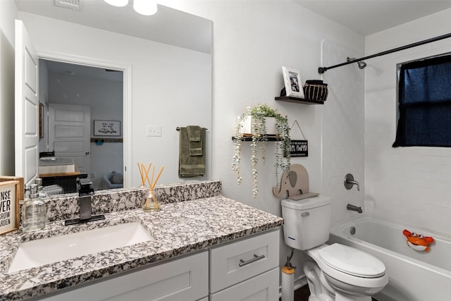 full bathroom with tiled shower / bath combo, vanity, and toilet