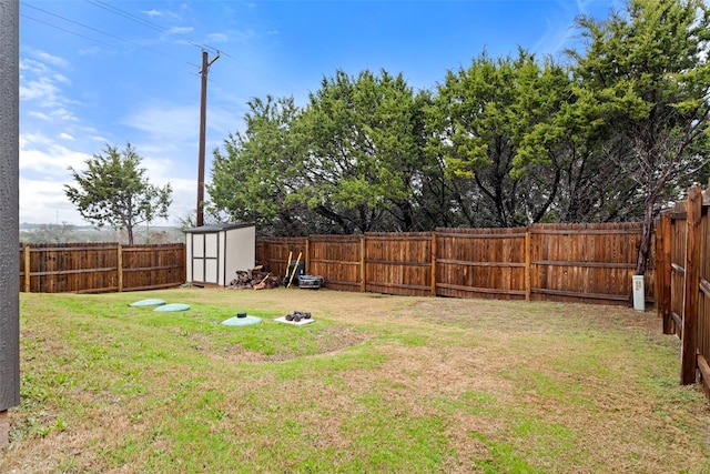 view of yard featuring a shed and an outdoor fire pit