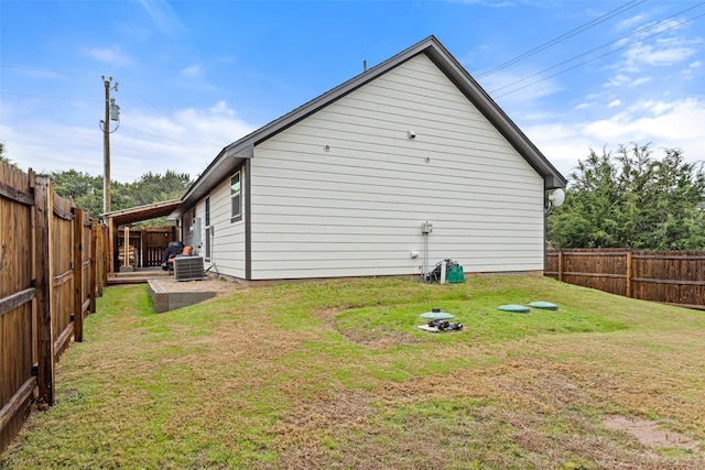 exterior space with a yard and central air condition unit