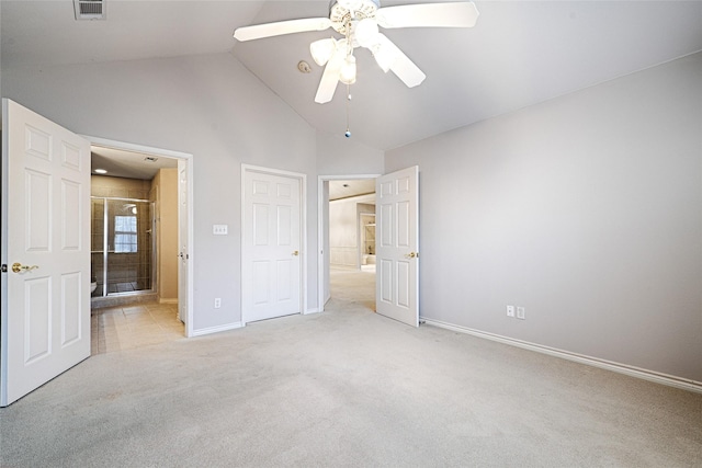 unfurnished bedroom with ceiling fan, vaulted ceiling, and light carpet