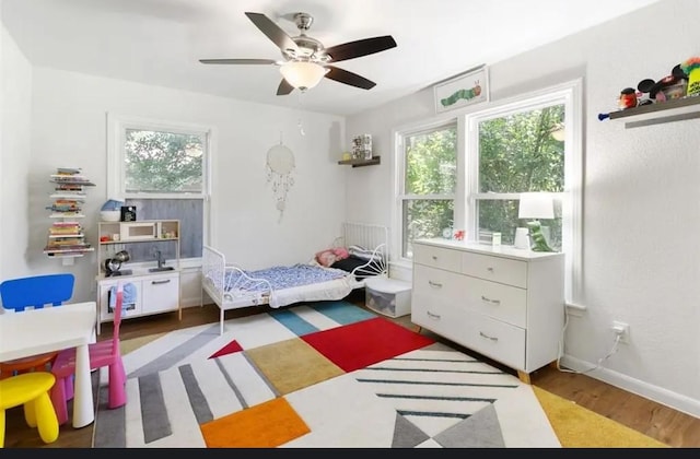 bedroom featuring wood-type flooring and ceiling fan